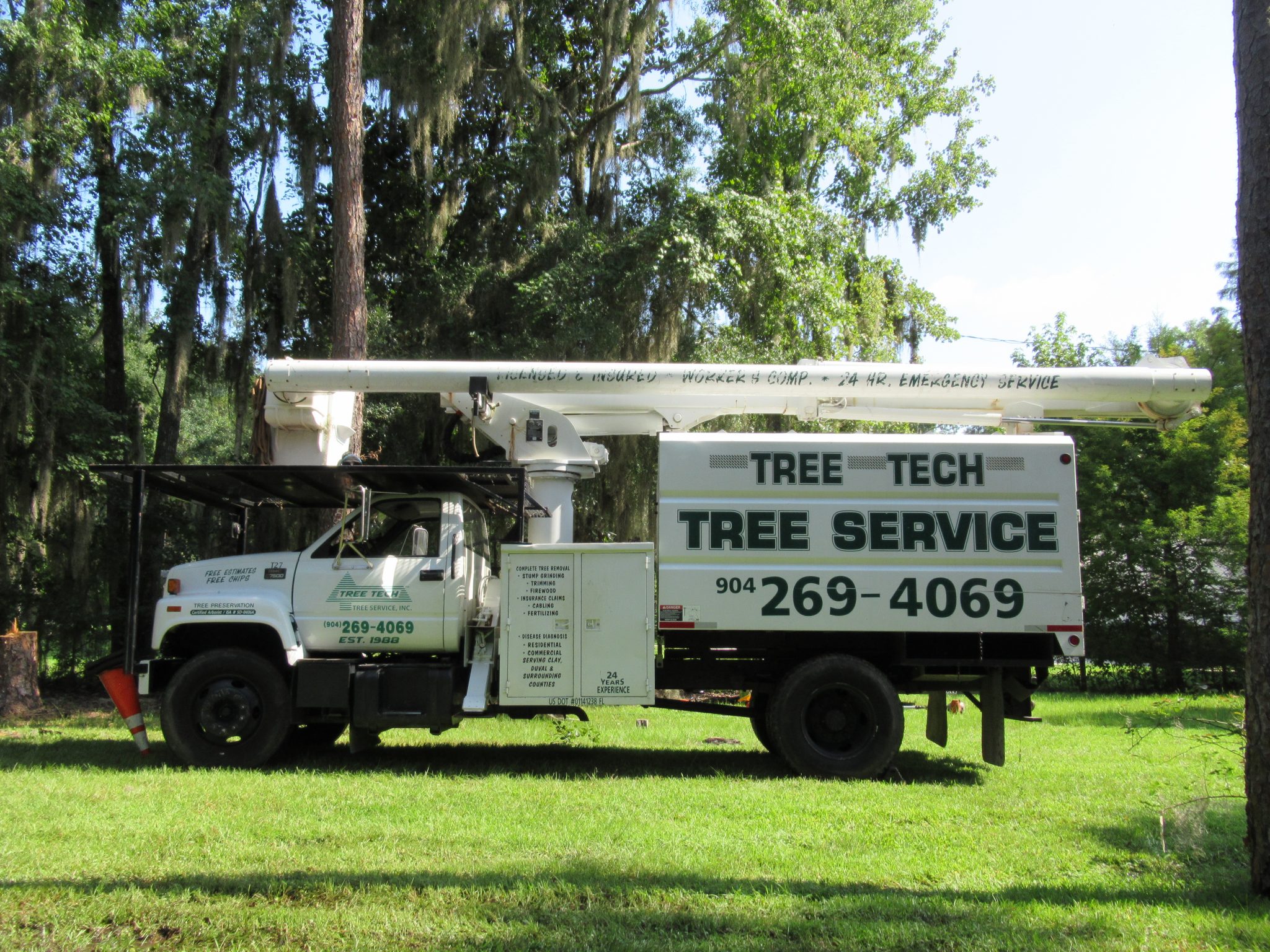 Side view of a Tree Tech Tree Service, Inc. truck.